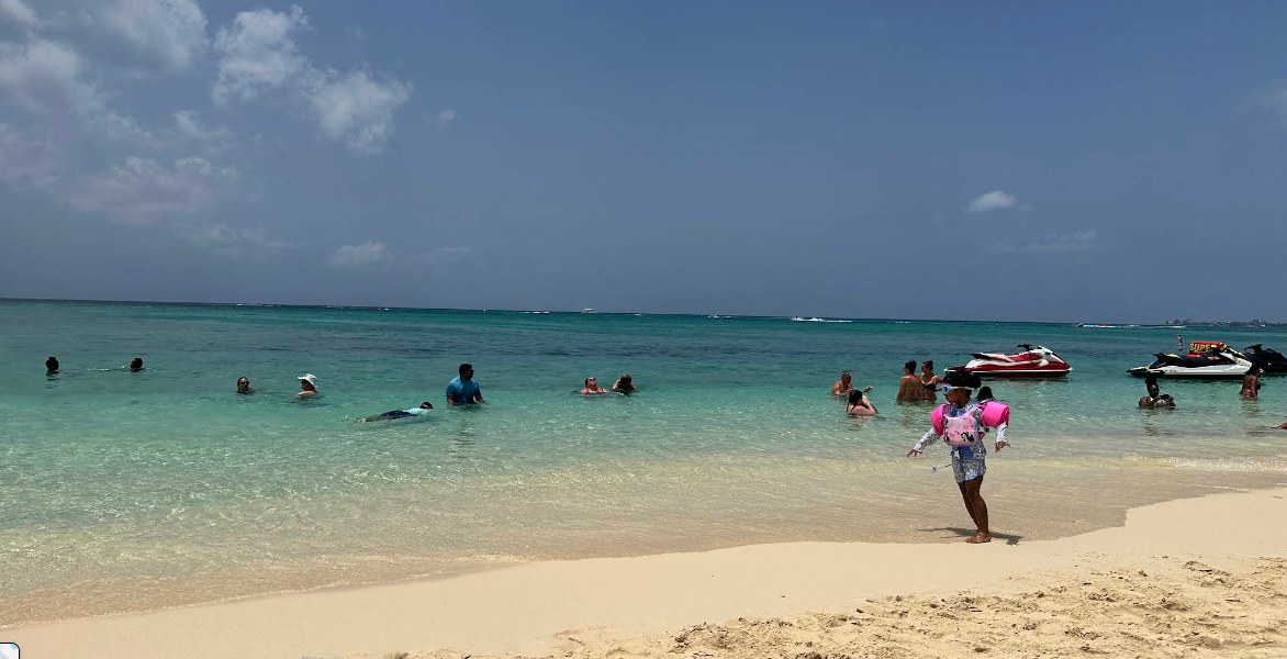 Swimmers in turquoise water on Seven Mile Beach, Grand Cayman