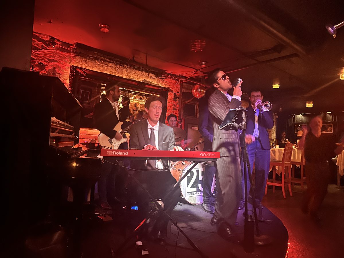Live R&B band with Xavier Solis on the small stage under red lighting at Reservoir Lounge, Toronto